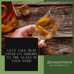 a hand holding a glass of alcohol
